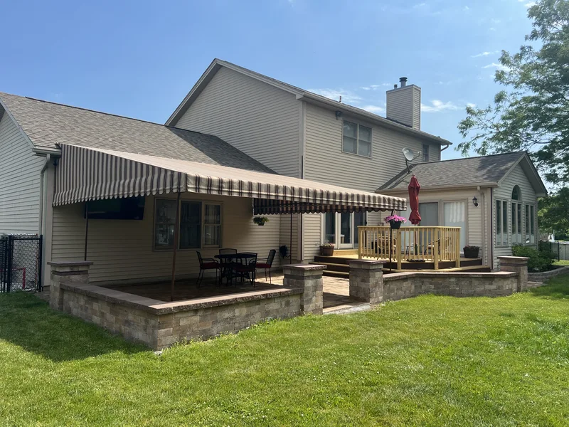 Raised patio and stone columns beside a home